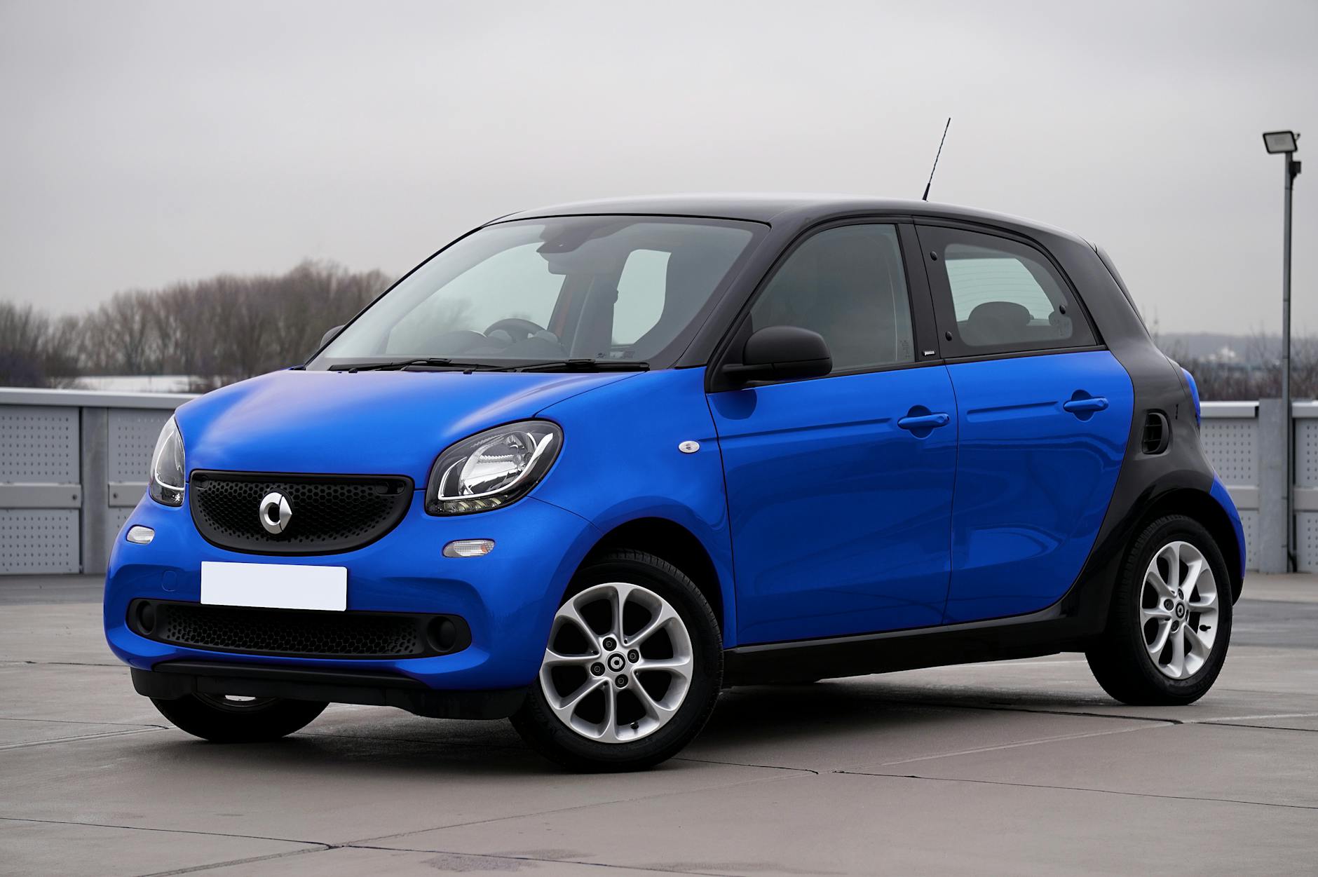 Niebieski Smart Forfour zaparkowany na ulicy w mieście