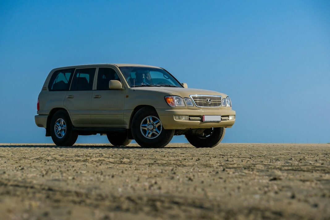 Beżowe Volvo SUV zaparkowane na pustynnym terenie pod błękitnym niebem